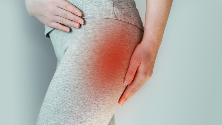 woman touching piriformis