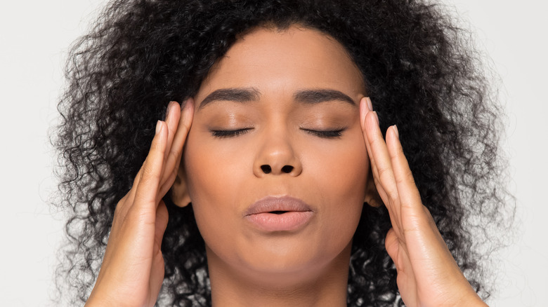 woman with vertigo feeling temples